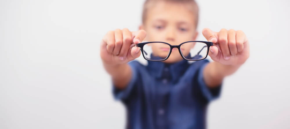 Kid holding eyeglasses